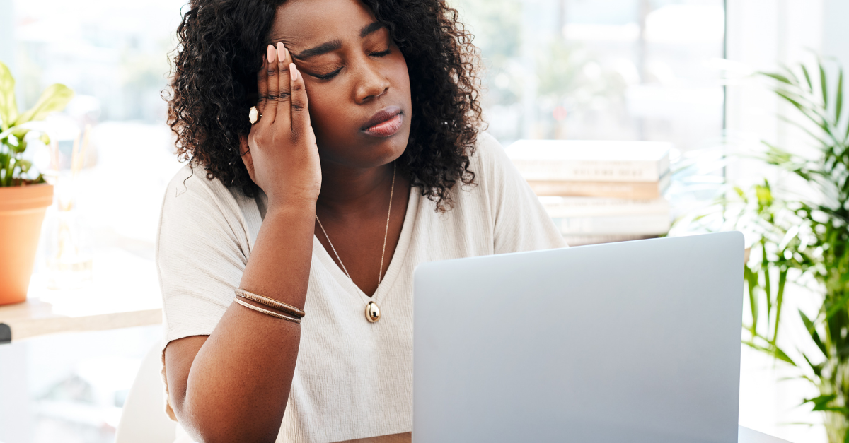 Early childhood educator looking at her computer screen frowning showing signs of burnout and not being supported at work