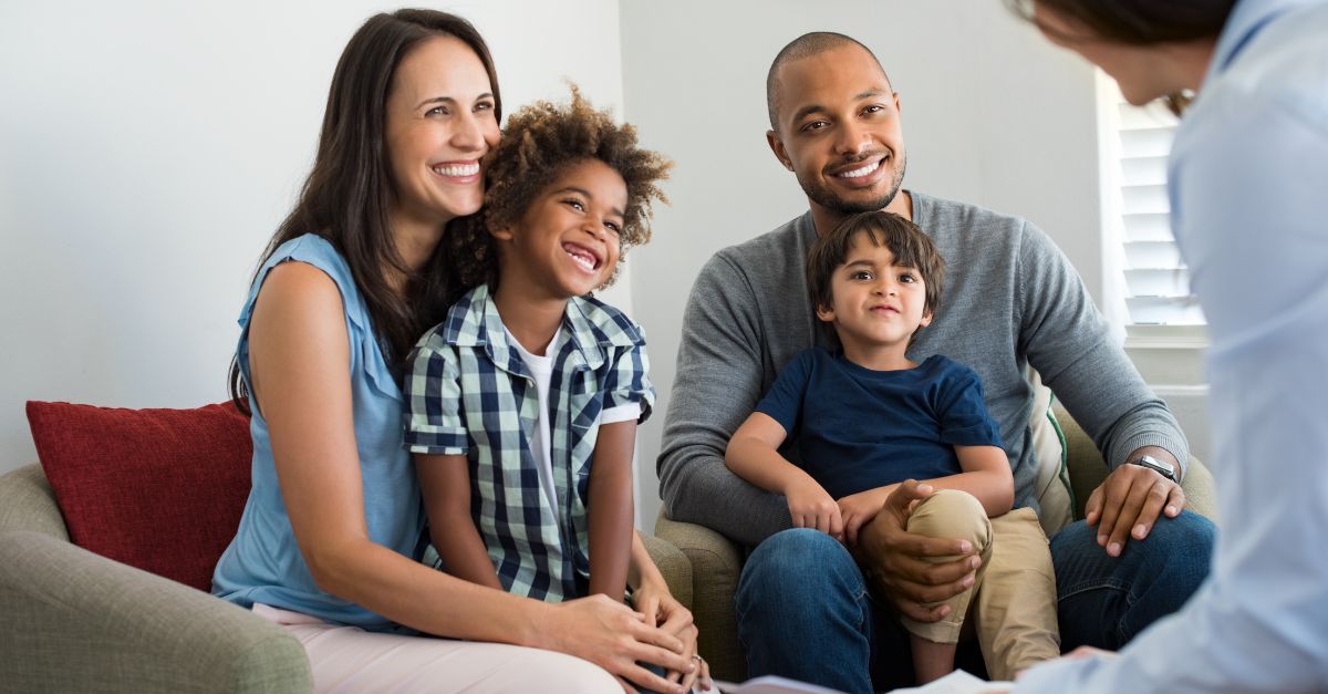 Family of four having an introduction meeting with a childcare center director
