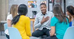 Group of early childhood educators sitting in a circle discussing mental health and how they can be supported at work 