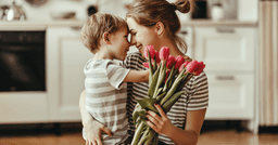 Preschool boy and mom holding a bouquet of tulips, hugging on mothers day. 