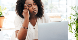 Early childhood educator looking at her computer screen frowning showing signs of burnout and not being supported at work