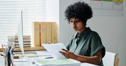 A childcare center director managing the centers finances using paper and having a scattered system