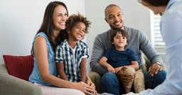 Family of four having an introduction meeting with a childcare center director