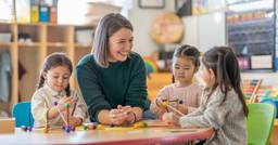 A picture of a happy teacher who has set professional boundaries and is not experiencing burnout 