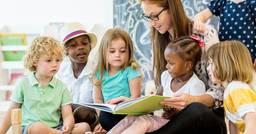Preschool teacher leading a story time session 
