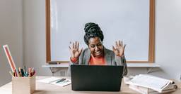 A childcare director celebrating a successful digital marketing campaign for her center