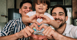 Two fathers playing with their child on father's day