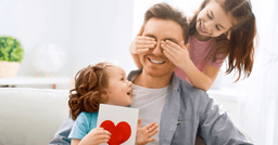 Two kids giving their Father's day craft to their father