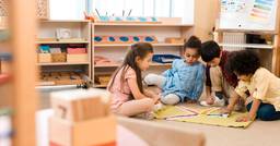 Four kindergarten aged children in a Montessori classroom