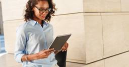 Childcare owner reviewing various grants and funding opportunities on her Ipad