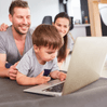 Family with child in front of computer