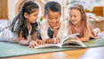 Kids reading a book together