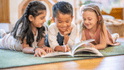 Kids reading a book together