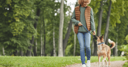 A home childcare provider taking a break and walking their dog in a local trail. 