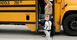 A child arriving for their first day of childcare after having their parent checking off everything they needed for the first day