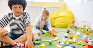 Two preschool children engaging in cooperative play together