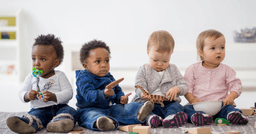 Group of toddlers engaging in a toy animal washing station during free play time