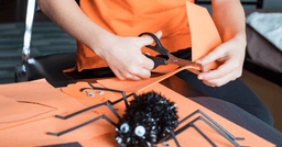 Preschooler working on a Halloween craft project