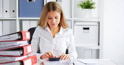 Childcare director organizing tax forms and invoices