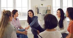 Group of Early Childhood Educators sitting in a circle as one educator leads them through a training and orientation